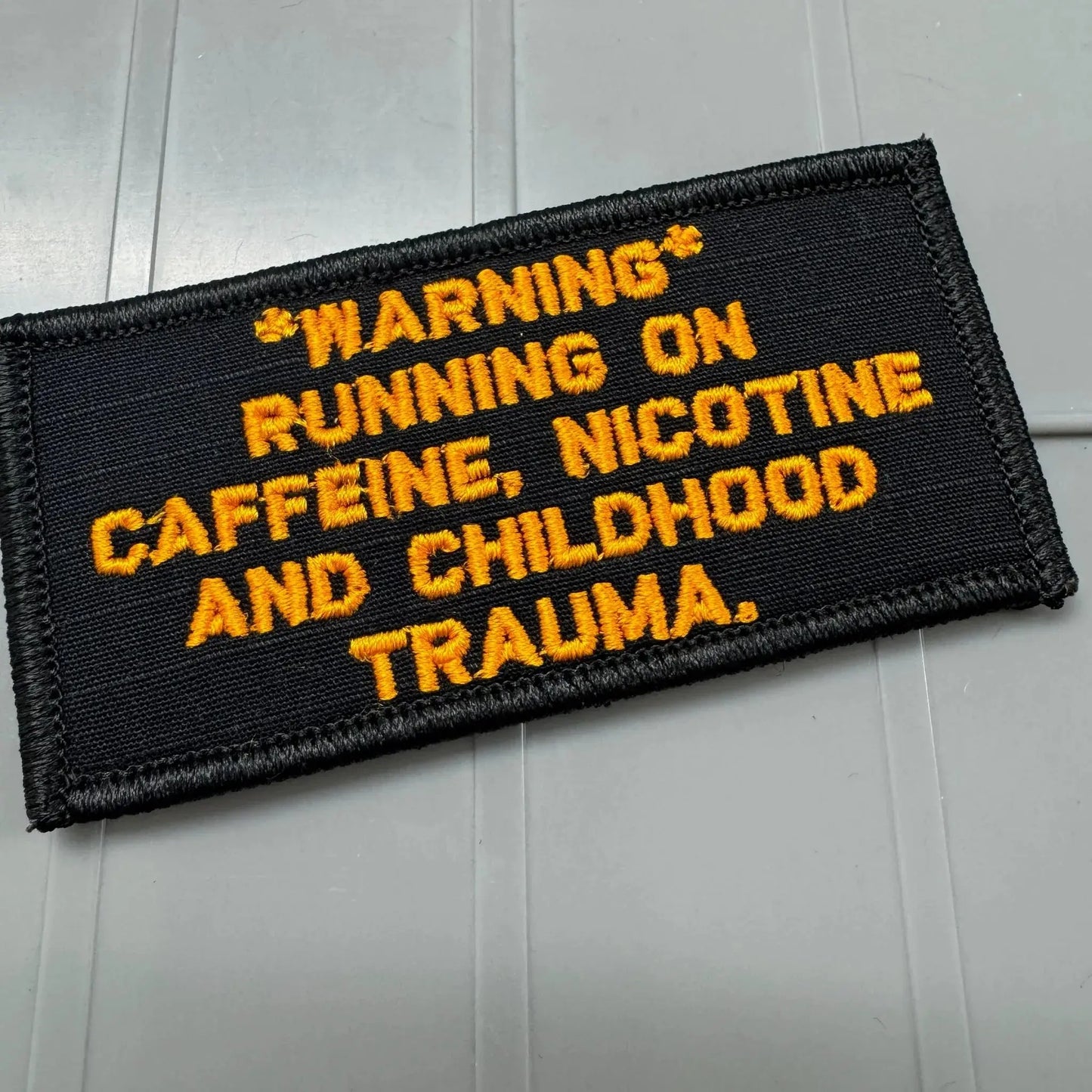 As Seen on Socials - *WARNING* Running on Caffeine, Nicotine and Chilhood Trauma - 2x4 Patch - Black w/Orange Tactical Gear Junkie