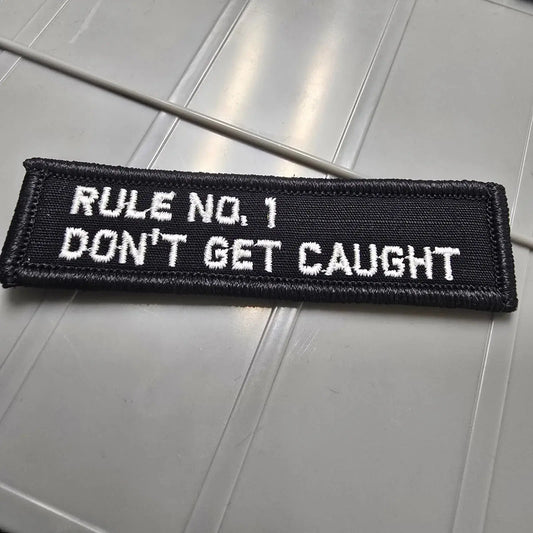 As Seen on Socials - Rule No. 1 - Don't Get Caught - 1x3.75 Patch - Black w/White Tactical Gear Junkie